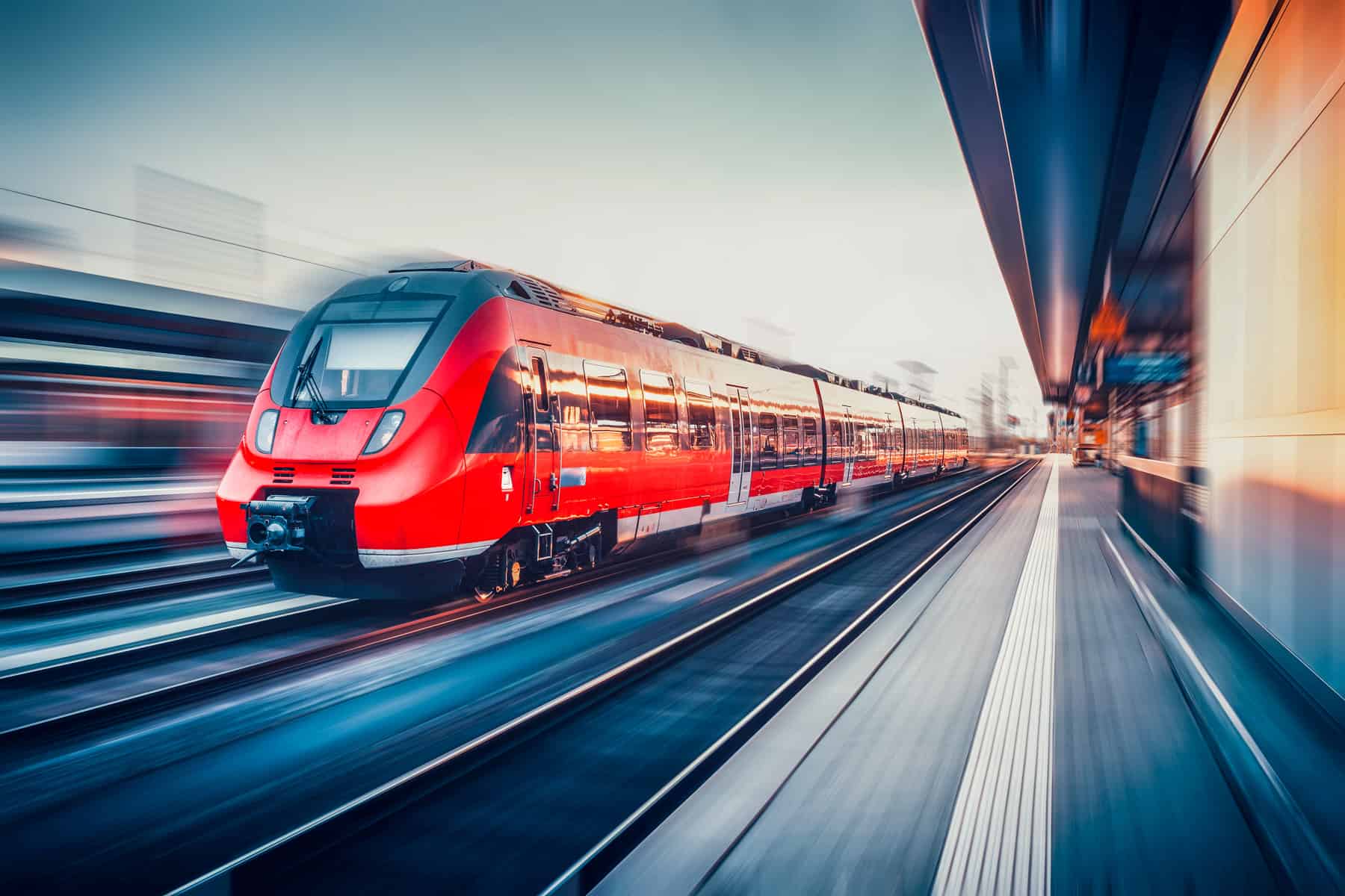 Beautiful railway station with modern red commuter train in moti